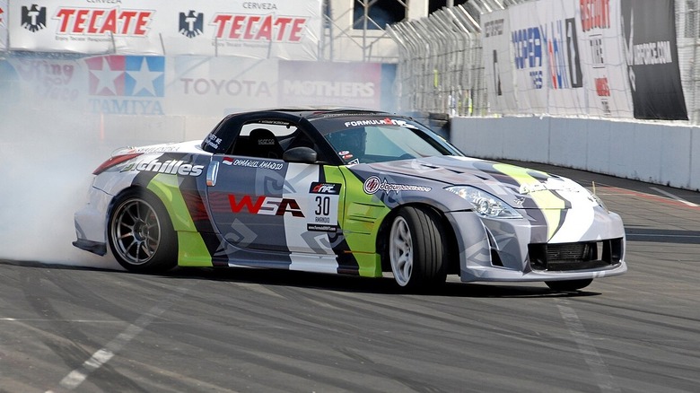 Formula DRIFT race car sliding through a turn on a closed track.
