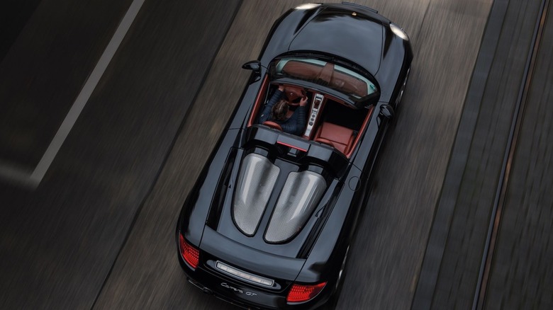 Aerial view of Porsche Carrera GT driving along road