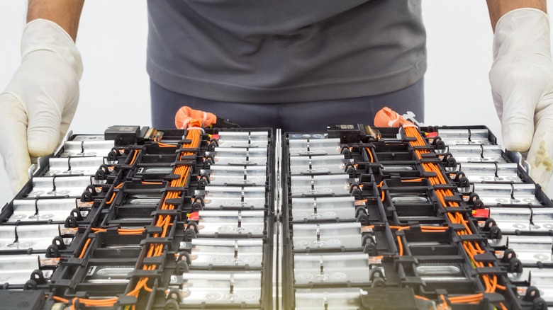 technician holding battery pack