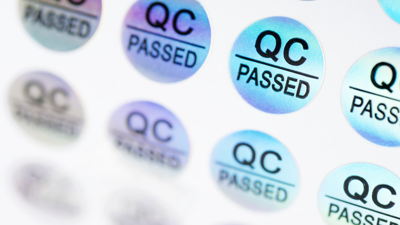 A close up of several QC Passed stickers