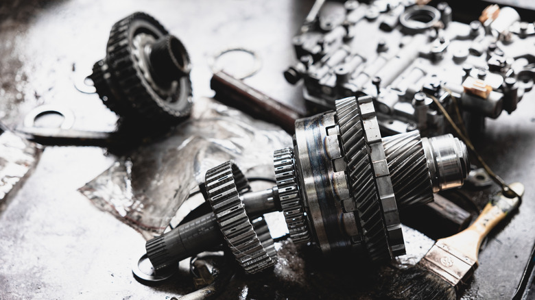 Parts of disassembled car transmission on workbench