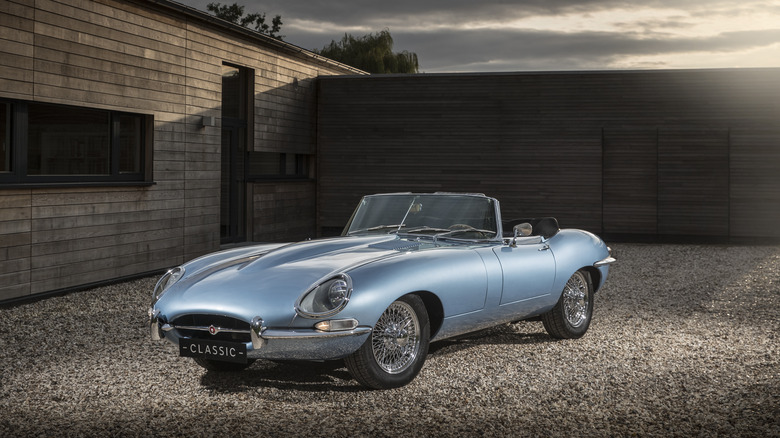 blue Jaguar E-type parked driveway