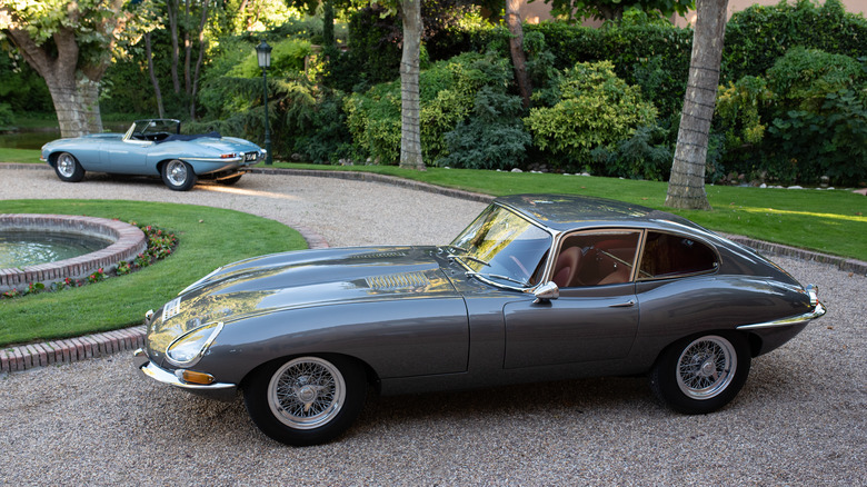 gray Jaguar E-type parked driveway