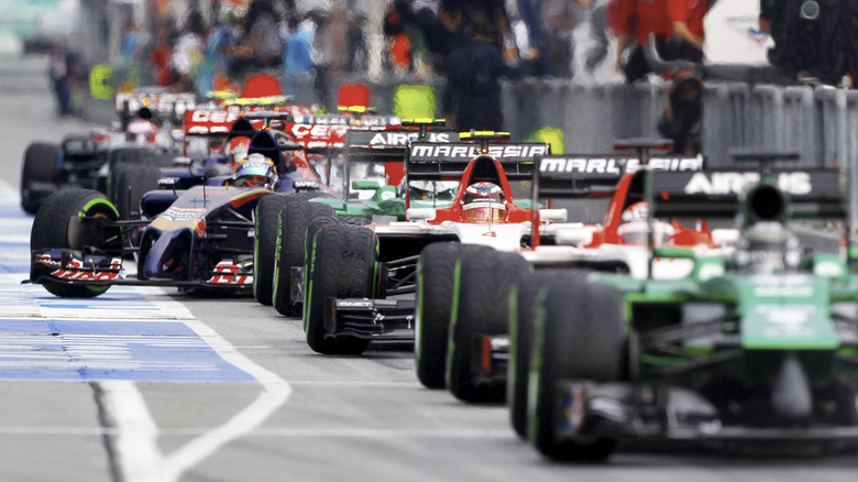 Hybrid V6-powered Formula 1 cars lined up on the side of Shanghai Circuit in 2014.