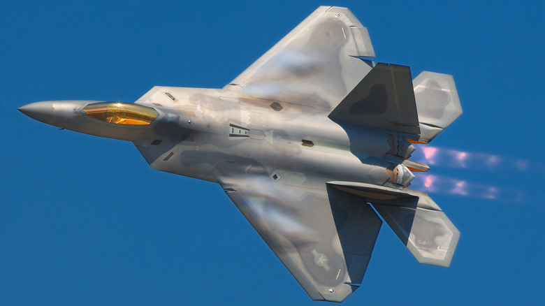 F-35 fighter jet in flight with afterburners on and shock diamonds visible in the exhaust gases.