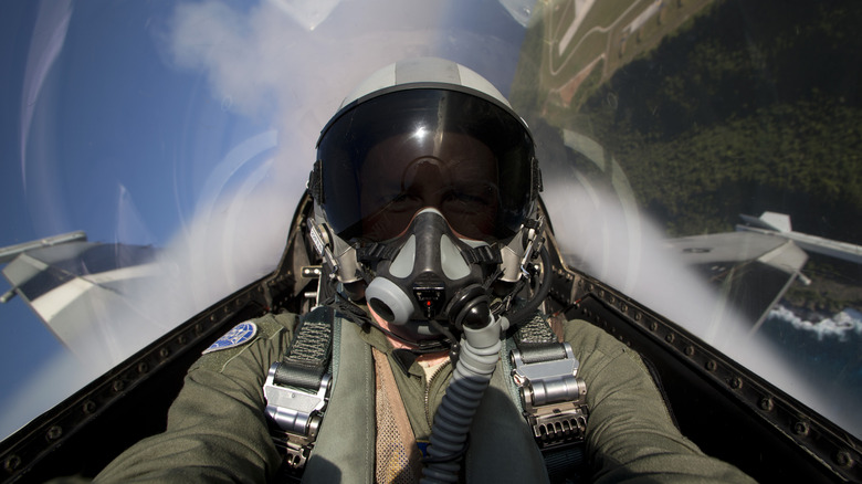 Fighter pilot with full mask in the air