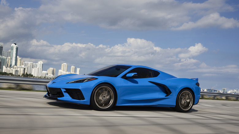 Front 3/4 view of a blue 2024 Chevrolet Corvette Stingray on the move