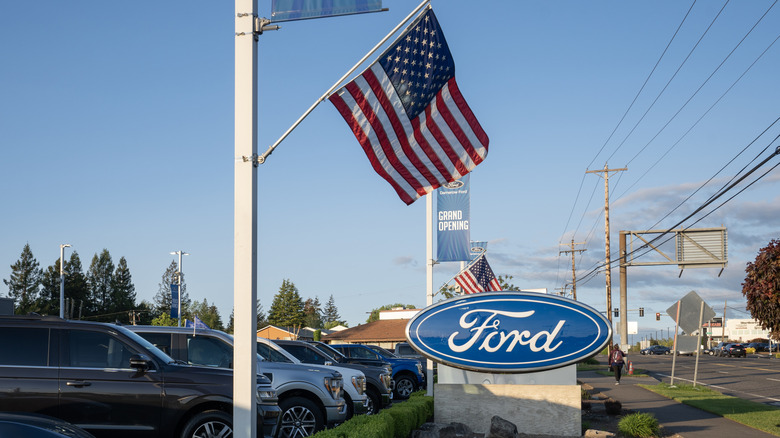 American flags fluttering outside of a Ford dealership in Beaverton, Oregon.
