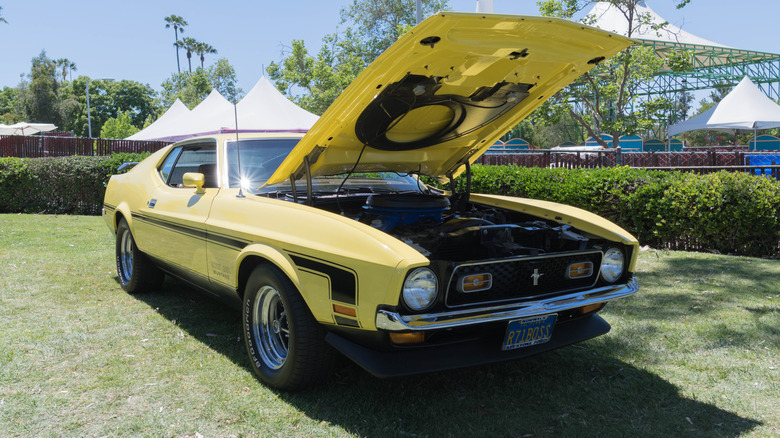 Ford Mustang Boss 351 with hood up showing engine at car show