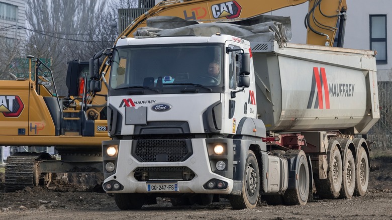 A white Ford truck working on a construction site