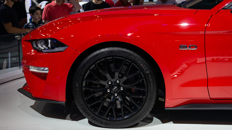 The front end of red Ford Mustang GT with the 5.0-liter Coyote V8 engine