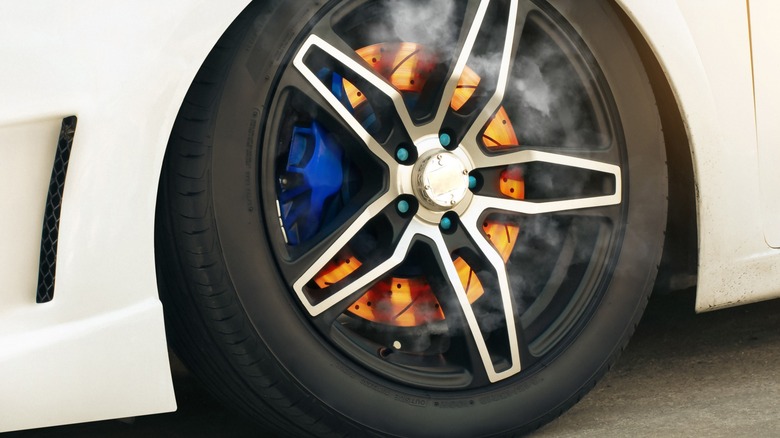 red-hot brake rotors with steam around it
