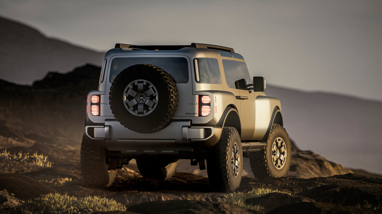 Rear 3/4 view of the Hyundai Boulder concept on a rocky surface, CG render