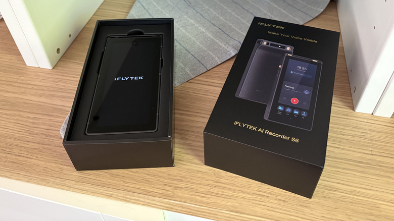 Product photo of iFlyTek AI voice recorder with box top removed to show product