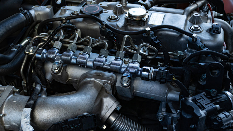 A close-up of modern diesel truck engine bay with fuel lines and hoses