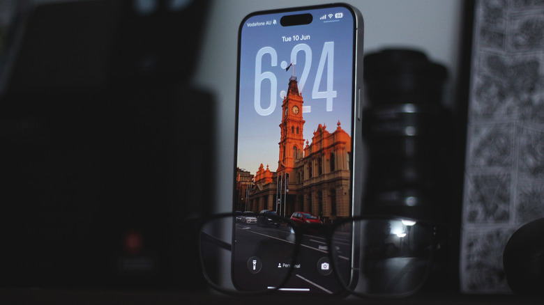 iOS 26 lock screen with Liquid Glass UI