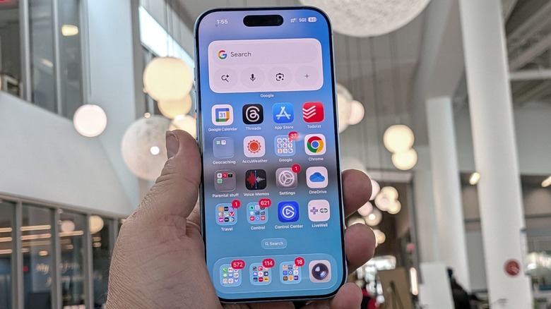 iPhone 17 held in hand at library.