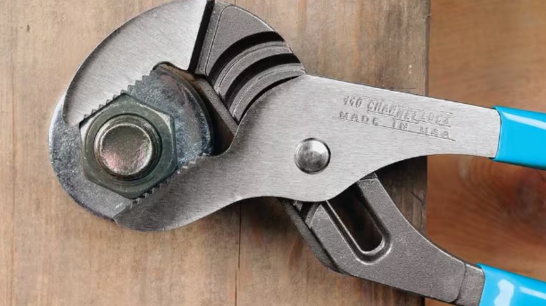 Closeup of a pair of Channellock tongue-and-groove pliers on a bolt