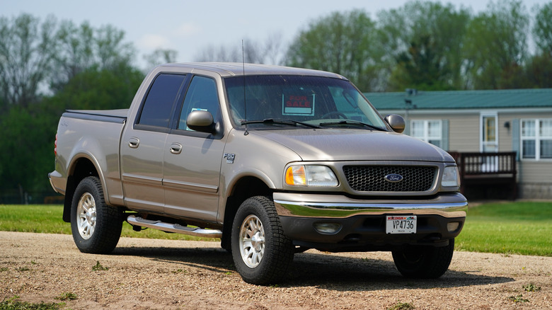 2001 Ford F-150 parked on dirt driveway, front-right 3/4 view