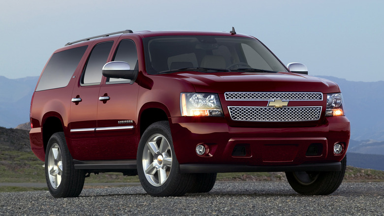 Front 3/4 view of red 2012 Chevrolet Suburban uses a Vortec 5300 engine