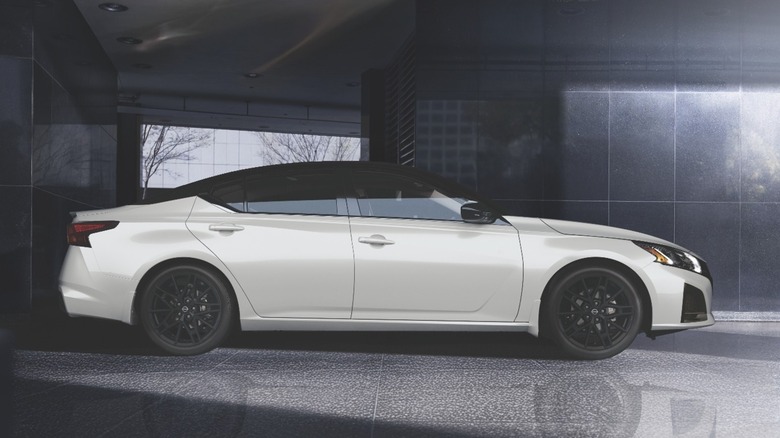 Side view of Nissan Altima in interior commercial setting