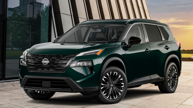 Front 3/4 view of 2026 Nissan Rogue in architectural setting