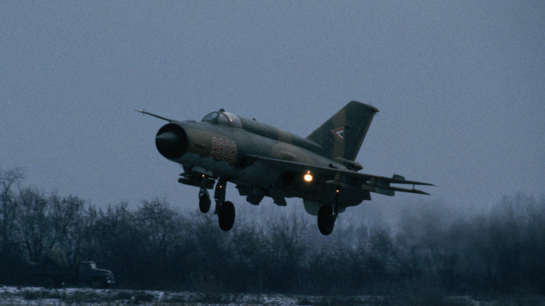 A MiG-21 fighter jet taking off.