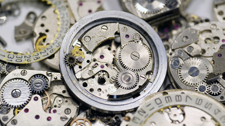 Image of various cogs and other internal workings of analog clocks