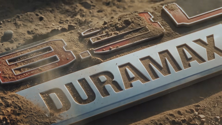 Dirt being blown off of the 8.3L Duramax logo