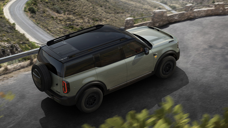 Top rear 3/4 view of Ford Bronco New Energy on mountain road