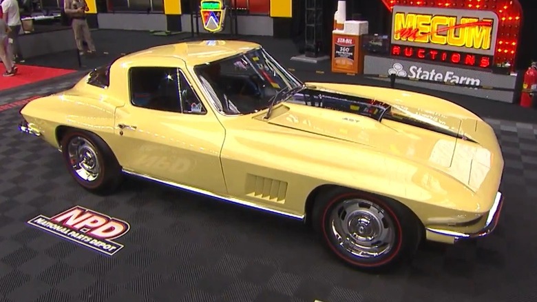 Yellow 1967 L88 Corvette on auction floor, front-right 3/4 view
