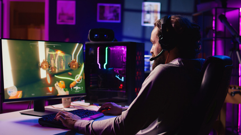 A man playing a video game on a PC