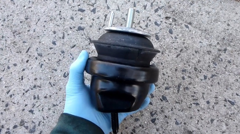 A person holding an engine mount.