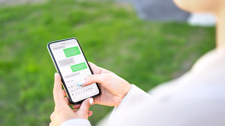 woman texting on a smartphone outdoors