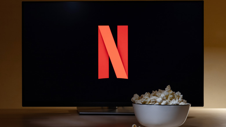 A TV with Netflix logo and a popcorn bowl infront of it