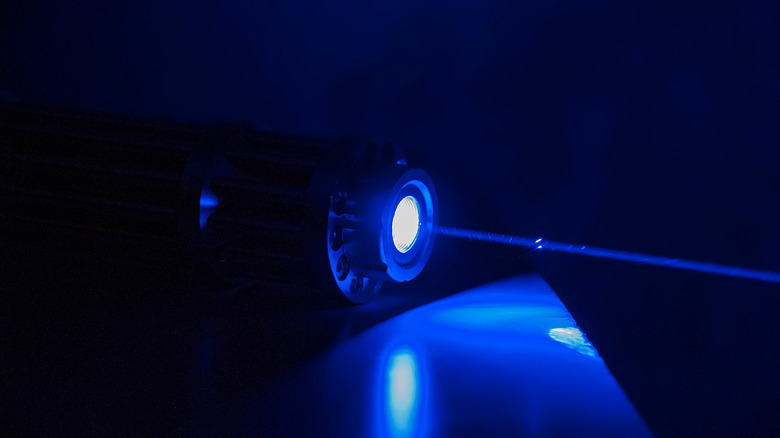 A blue laser light shining in the darkness