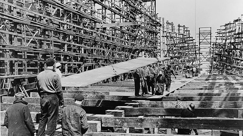 A photo of harbor workers assembling the keel of a Liberty ship