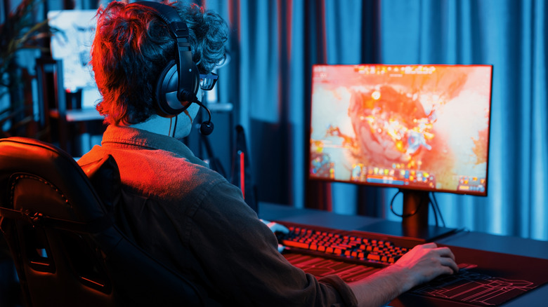 Person playing video game on PC