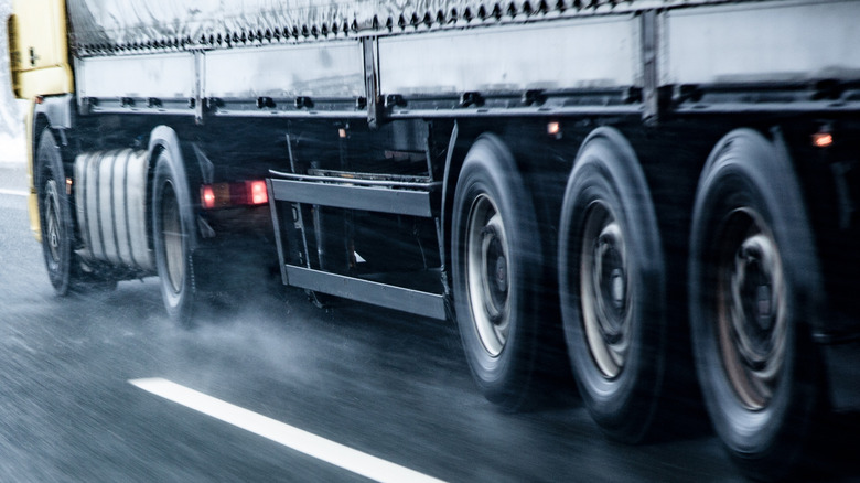 Truck driving on wet slippery road