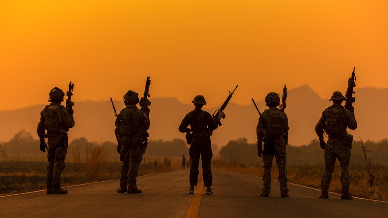Five soldiers on a sunset sky