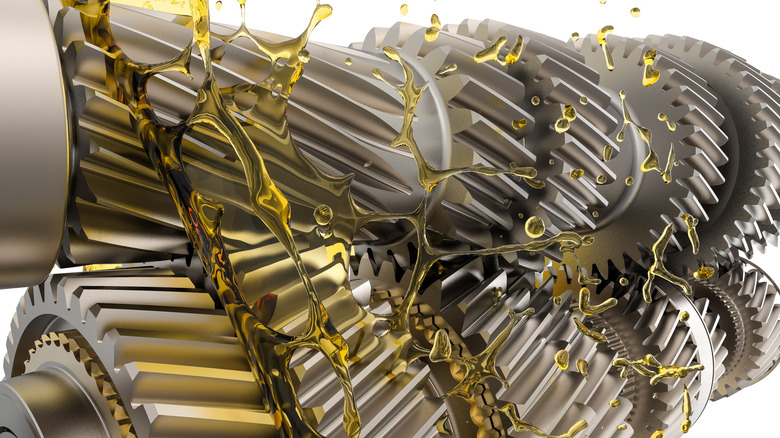 3D illustration of manual transmission gears with oil splashing around them