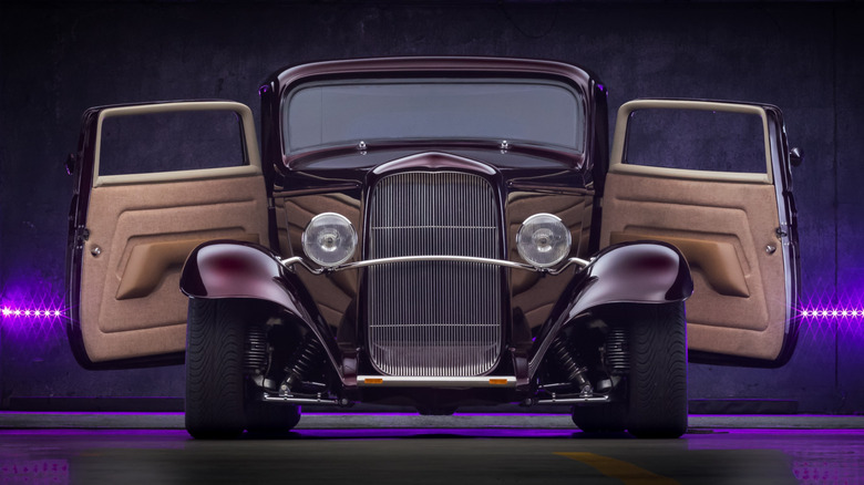 Frontal shot of a classic car with suicide doors open.