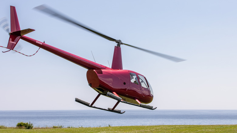 A red helicopter taking off