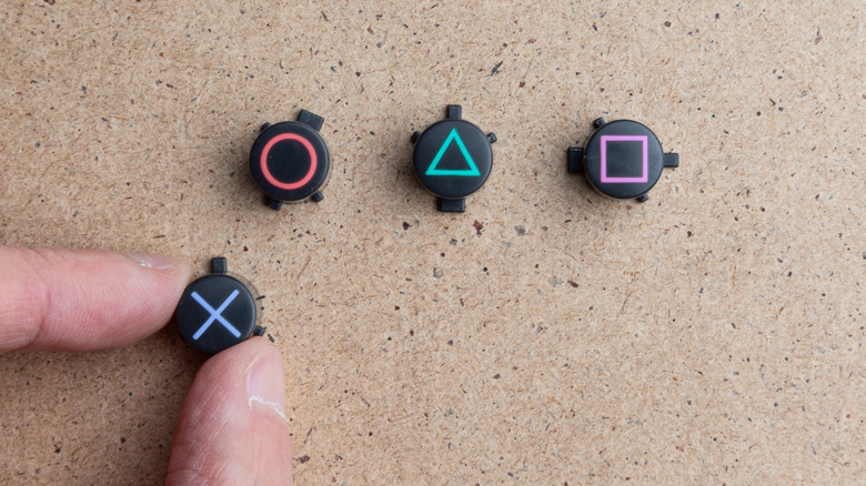 Playstation Gaming Controller Buttons arranged on corkboard
