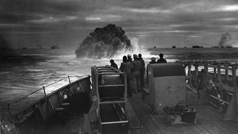 Vessel watches an explosion on the water's surface.