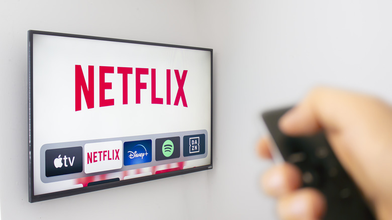 Person selecting Netflix app