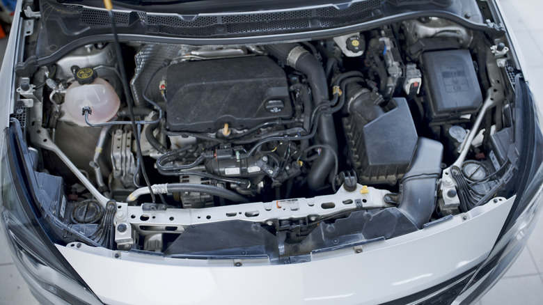 A top view of a modern car engine inside a hood.
