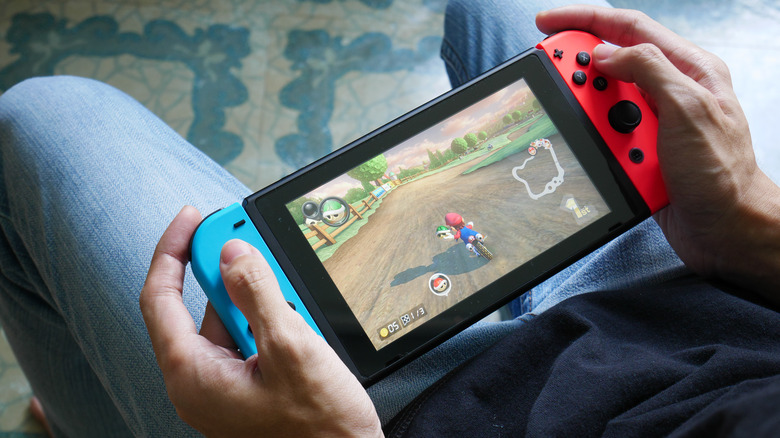 a man plays mario kart on a nintendo switch