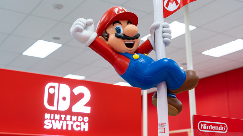 Mario figure holding onto a pole at a Nintendo Switch 2 booth