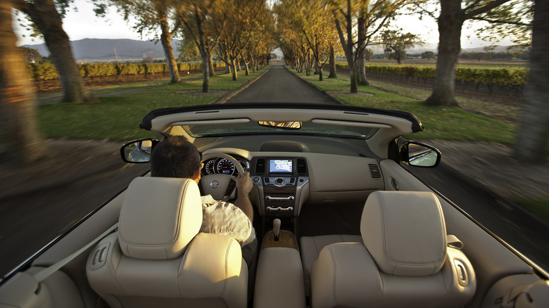 Interior shot of a 2011 Nissan Murano CrossCabriolet driving with the top down